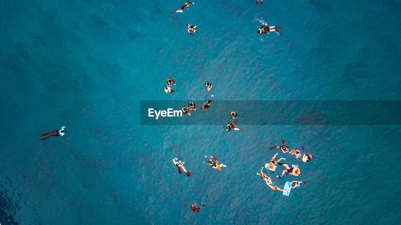 High angle view of people swimming in sea