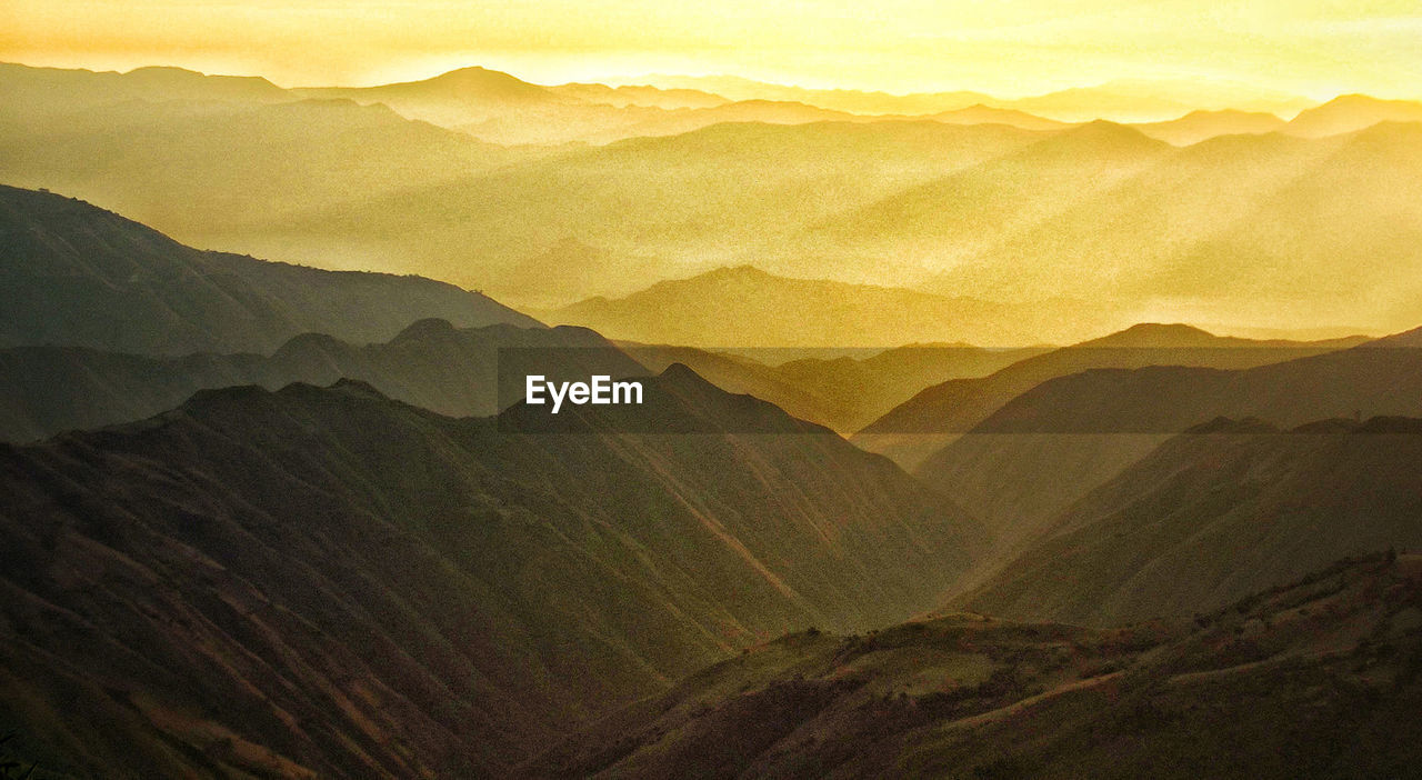 Scenic view of mountains against sky during sunset