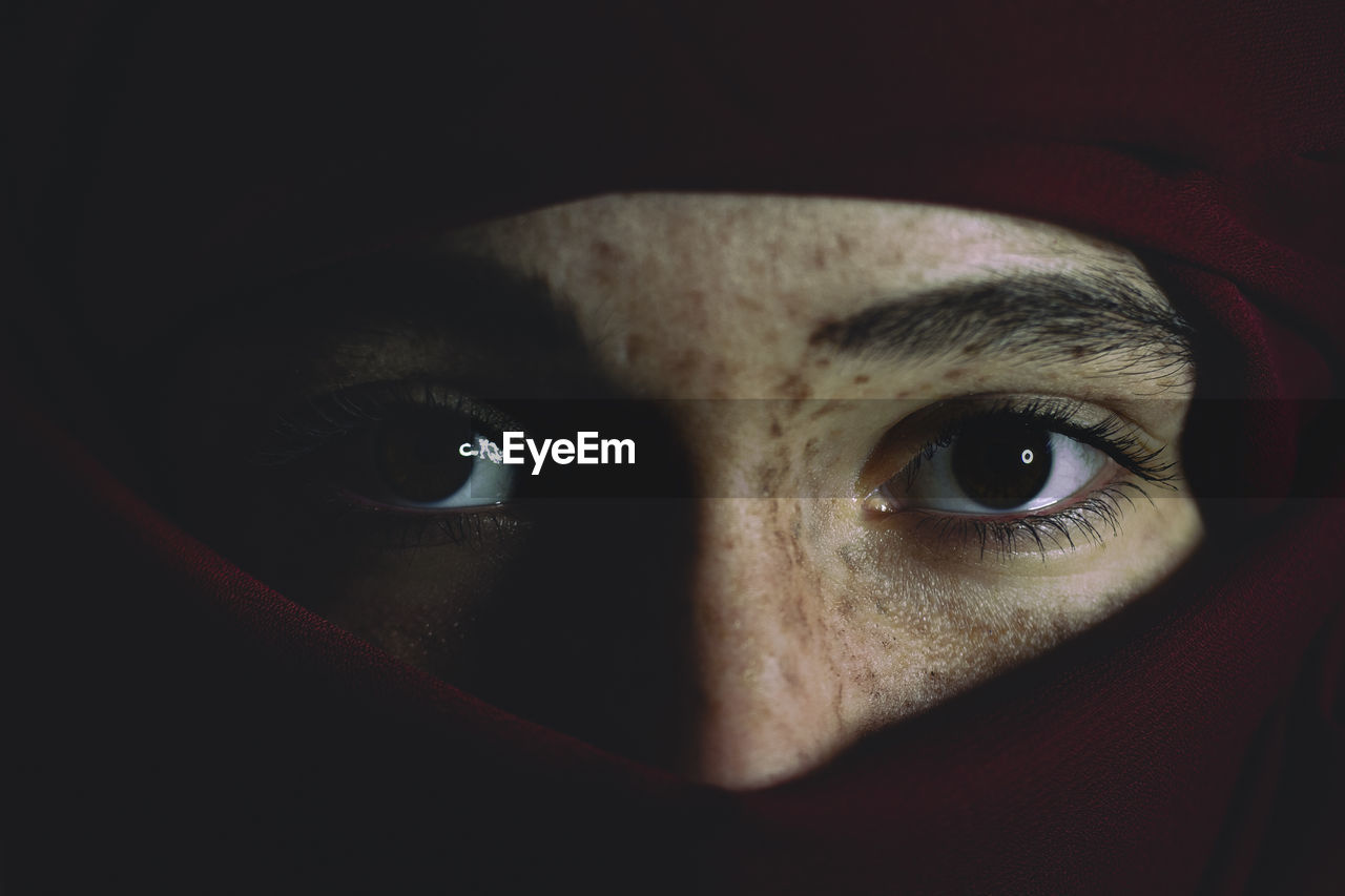 CLOSE-UP OF PORTRAIT OF WOMAN WITH BLACK EYES