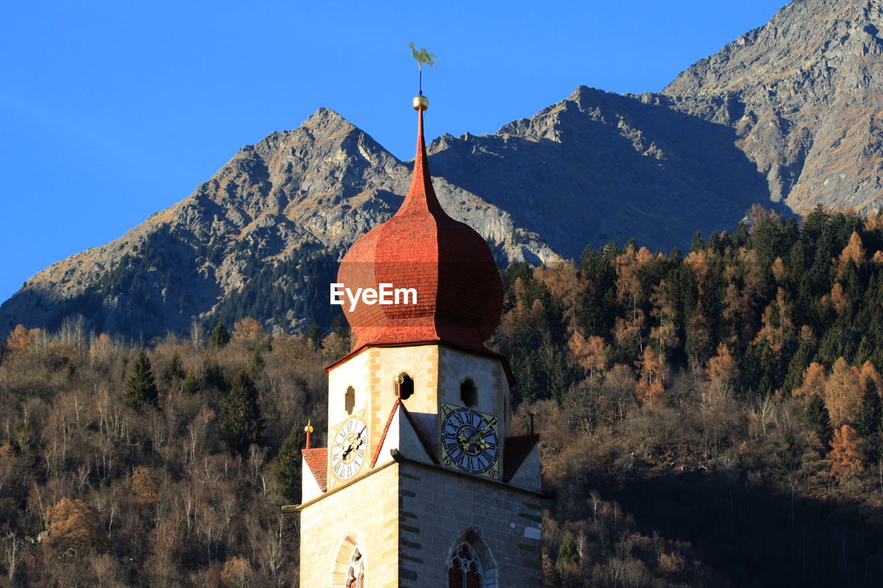 Low angle view of church by mountains