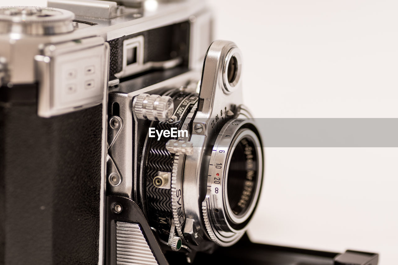 Close-up of vintage camera against white background