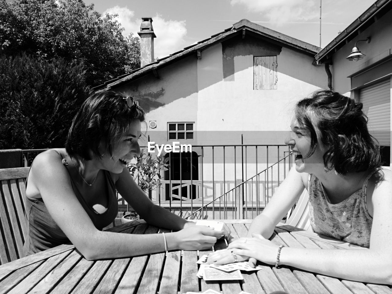 Happy female friends sitting at table in cafe