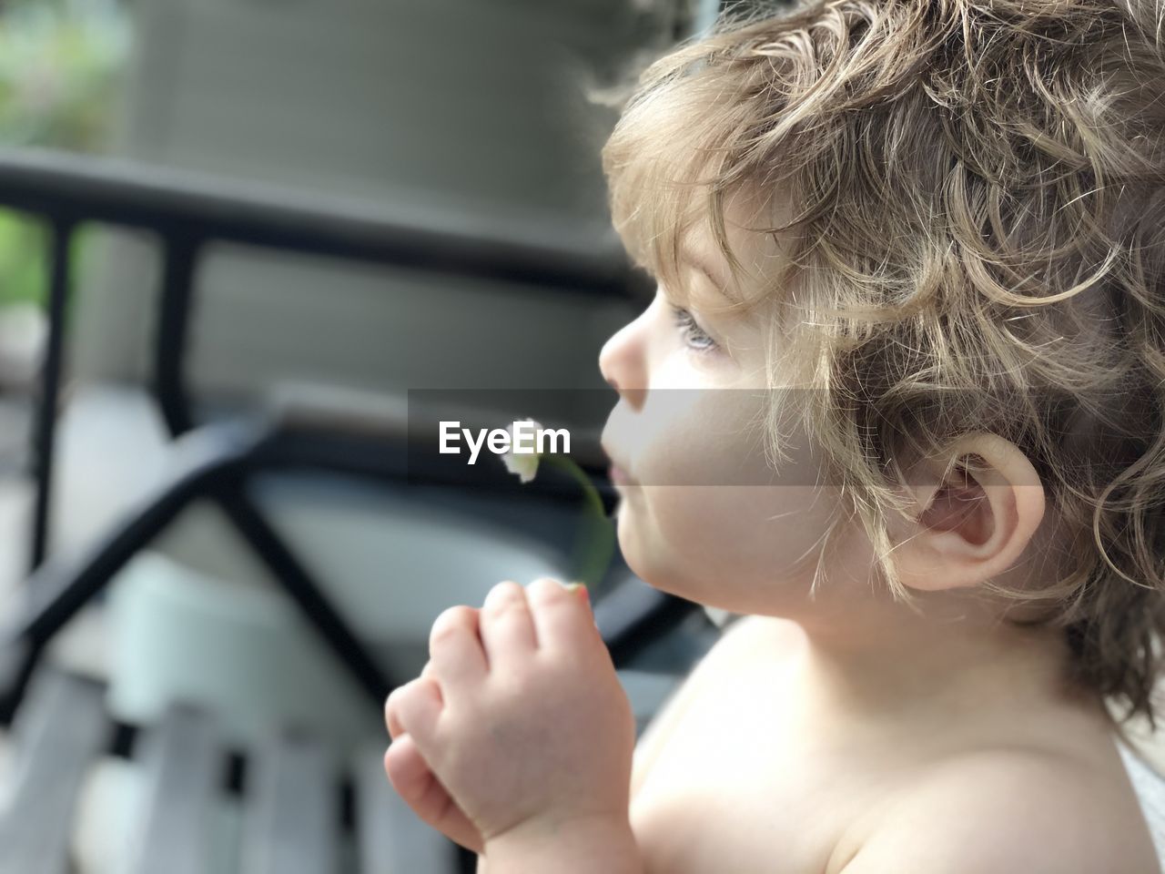 PORTRAIT OF BOY LOOKING THROUGH MAN HOLDING CAMERA