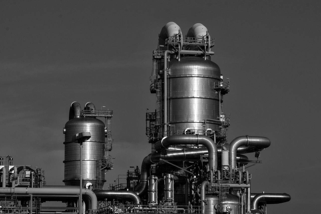 LOW ANGLE VIEW OF INDUSTRY AGAINST SKY AT FACTORY