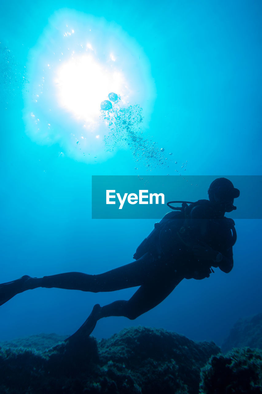 Low angle view of man swimming in sea