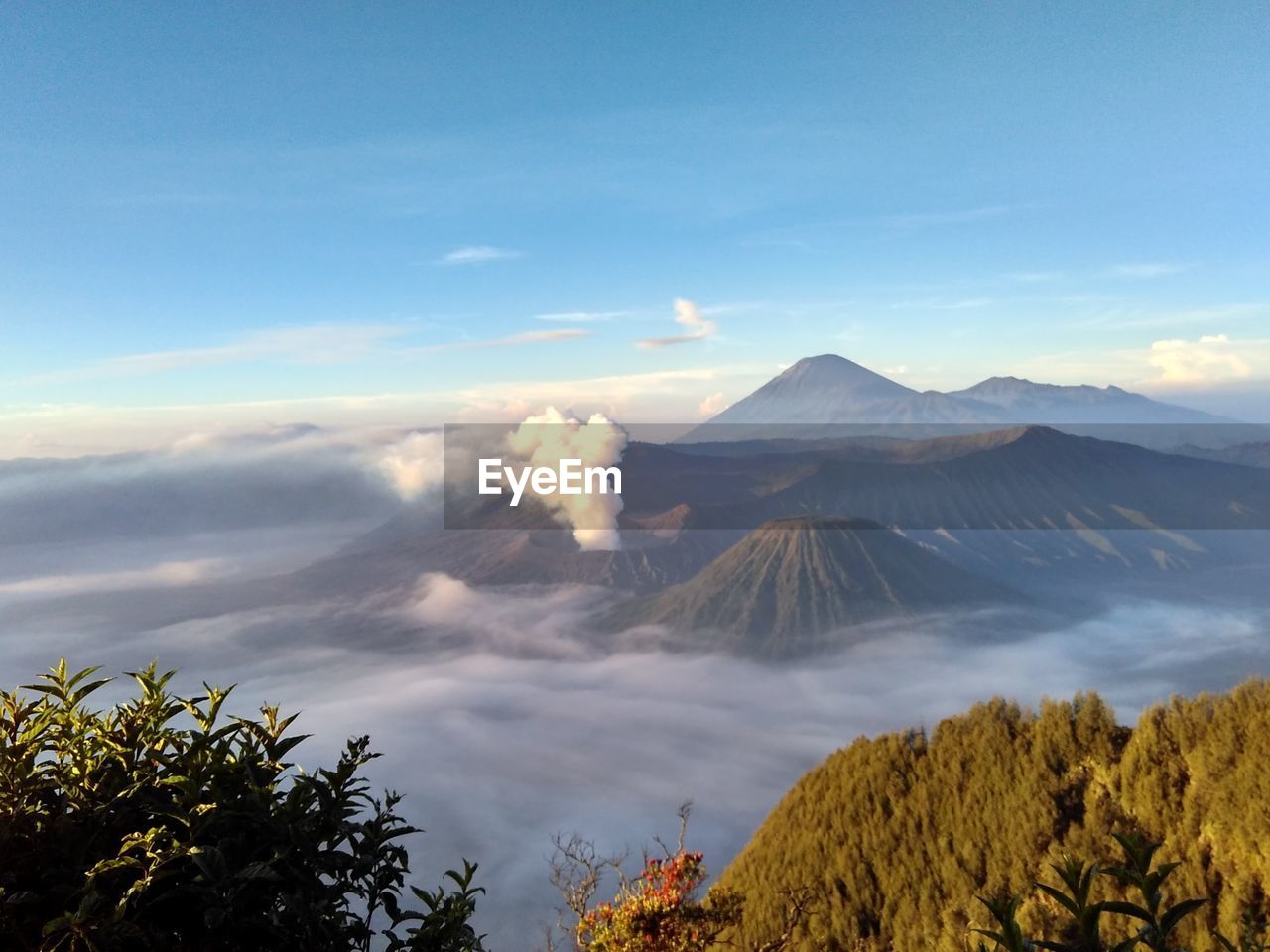 mountain, sky, volcano, nature, cloud, landscape, beauty in nature, environment, scenics - nature, land, plant, tree, wilderness, no people, travel destinations, morning, travel, volcanic landscape, volcanic crater, non-urban scene, smoke, fog, outdoors, mountain peak, geology, sunlight, tourism, horizon, active volcano, mountain range, tranquility, blue, day, tranquil scene, plateau, ridge, forest, erupting