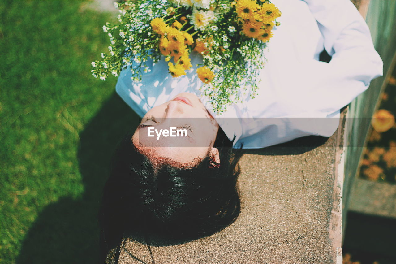 WOMAN HOLDING FLOWERS