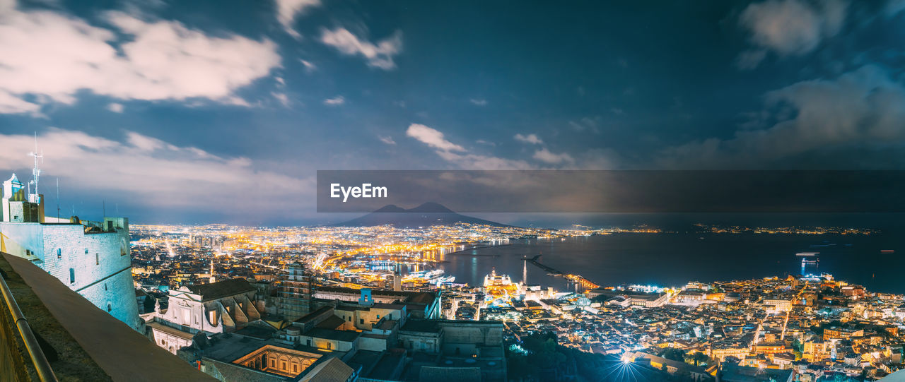 high angle view of illuminated buildings in city against sky at night