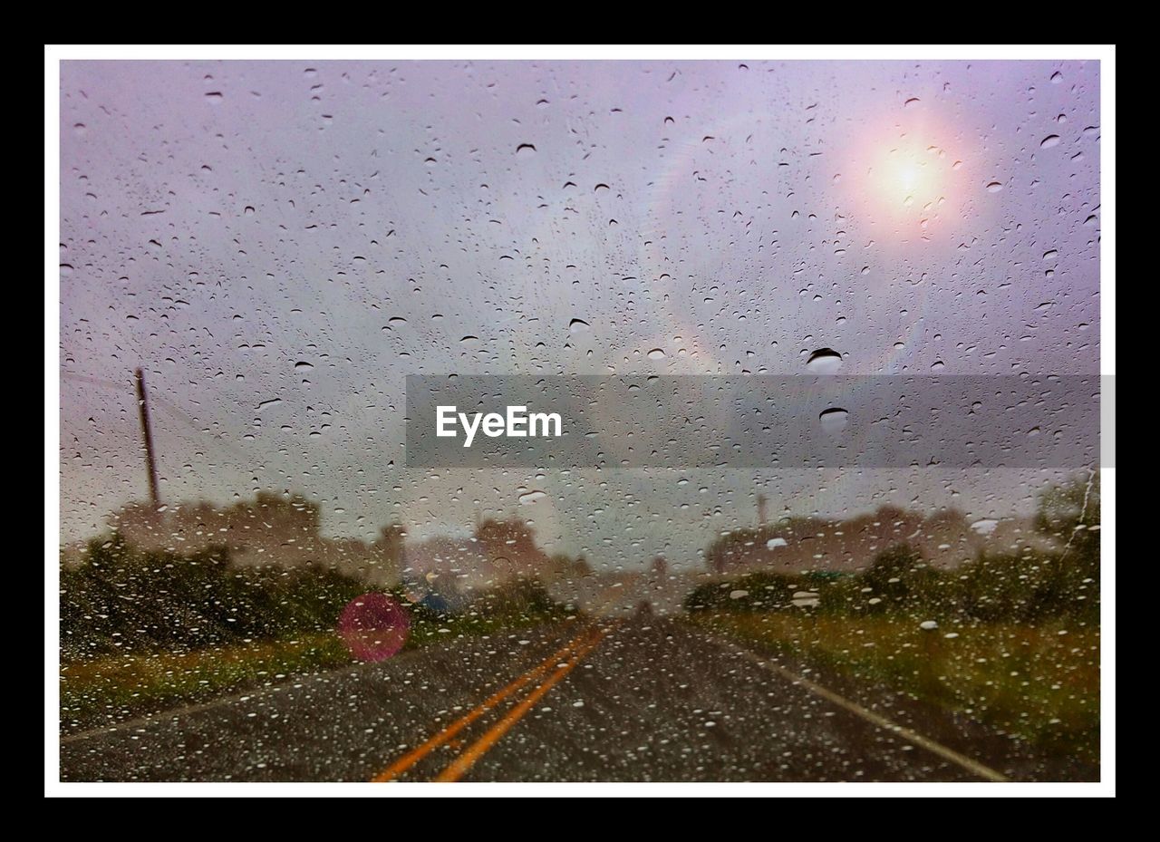 VIEW OF ROAD THROUGH CAR WINDOW