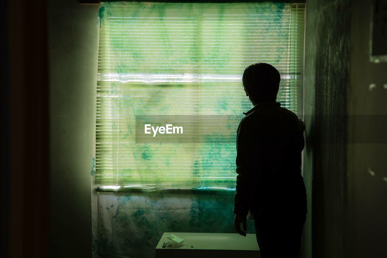 Man standing by blinds