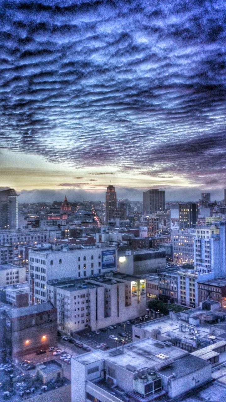 HIGH ANGLE VIEW OF CITY AGAINST CLOUDY SKY