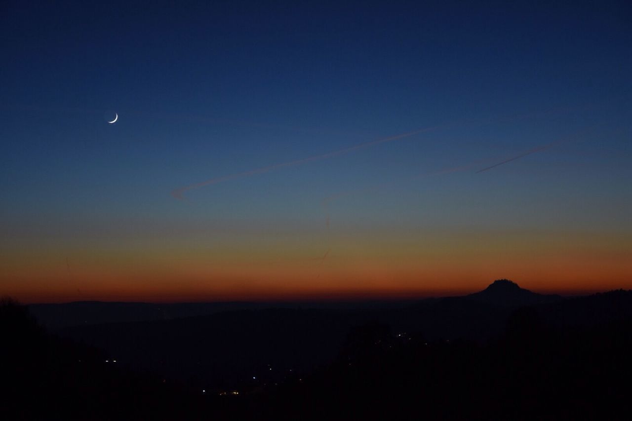 Scenic view of silhouette landscape against sky at night