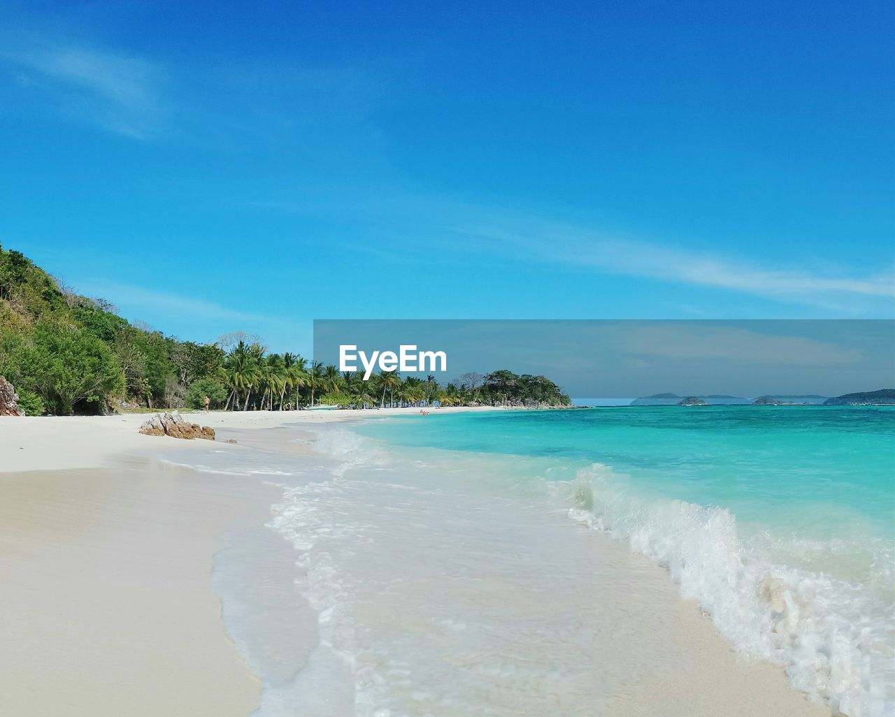 Scenic view of beach against blue sky