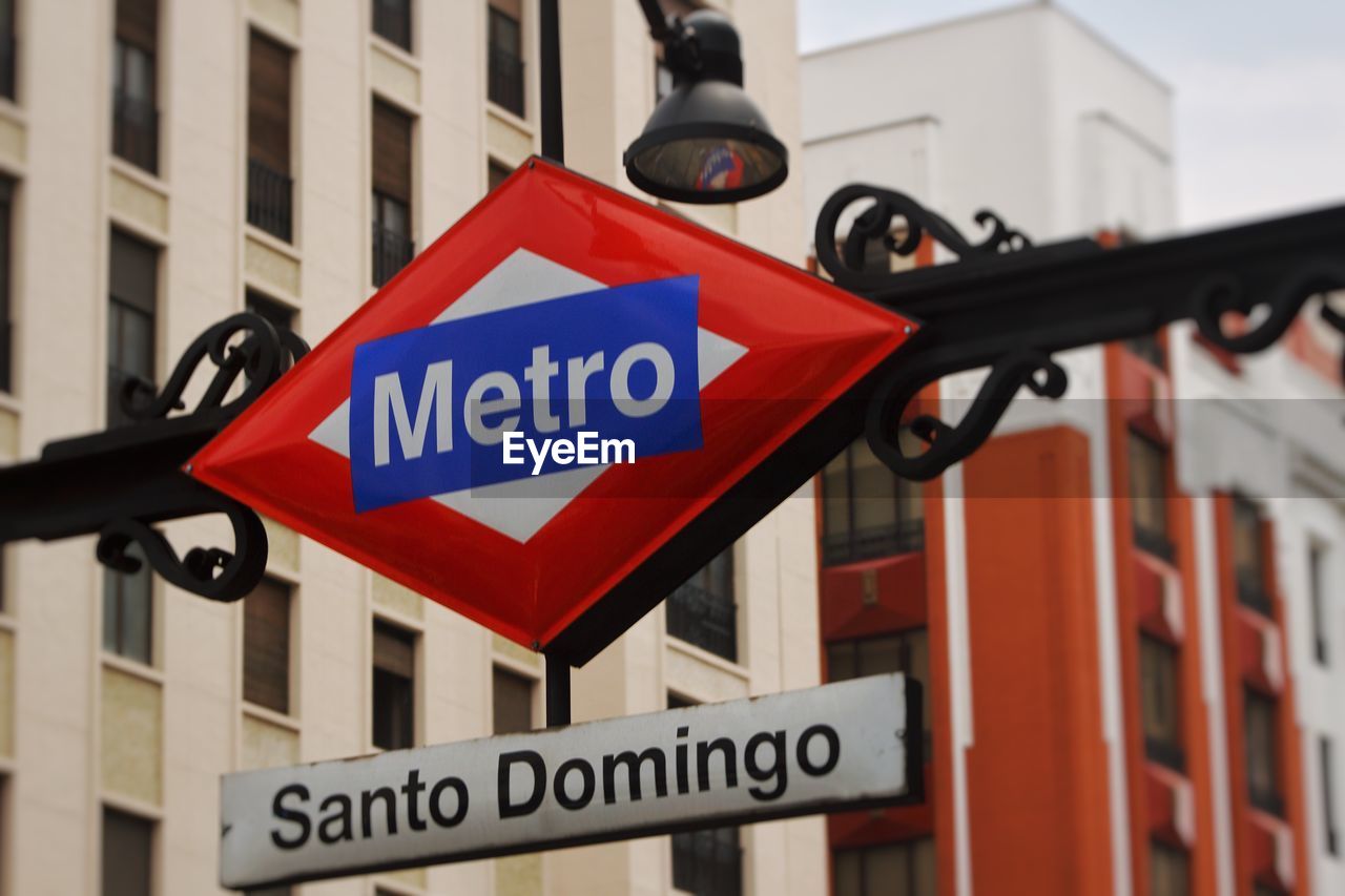 LOW ANGLE VIEW OF ROAD SIGN AGAINST BUILDING