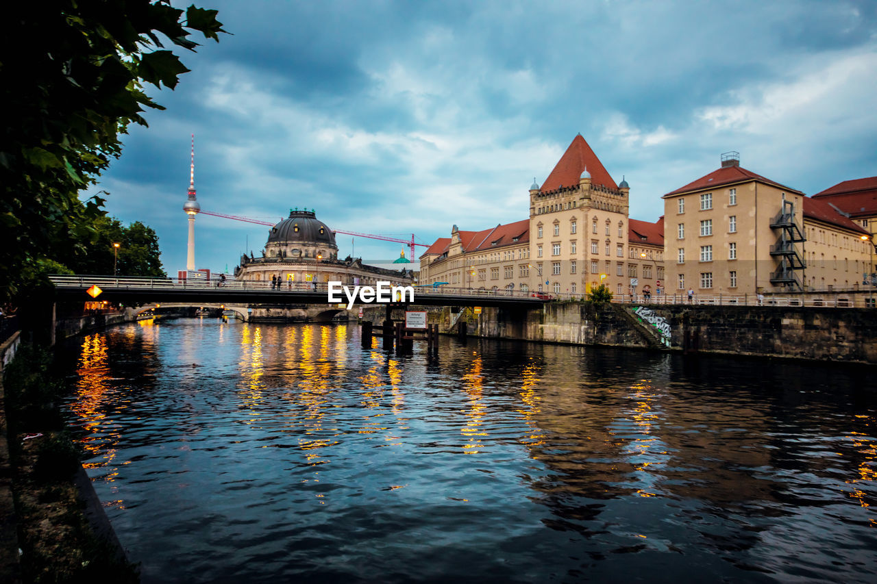 Bridge over river with buildings in background