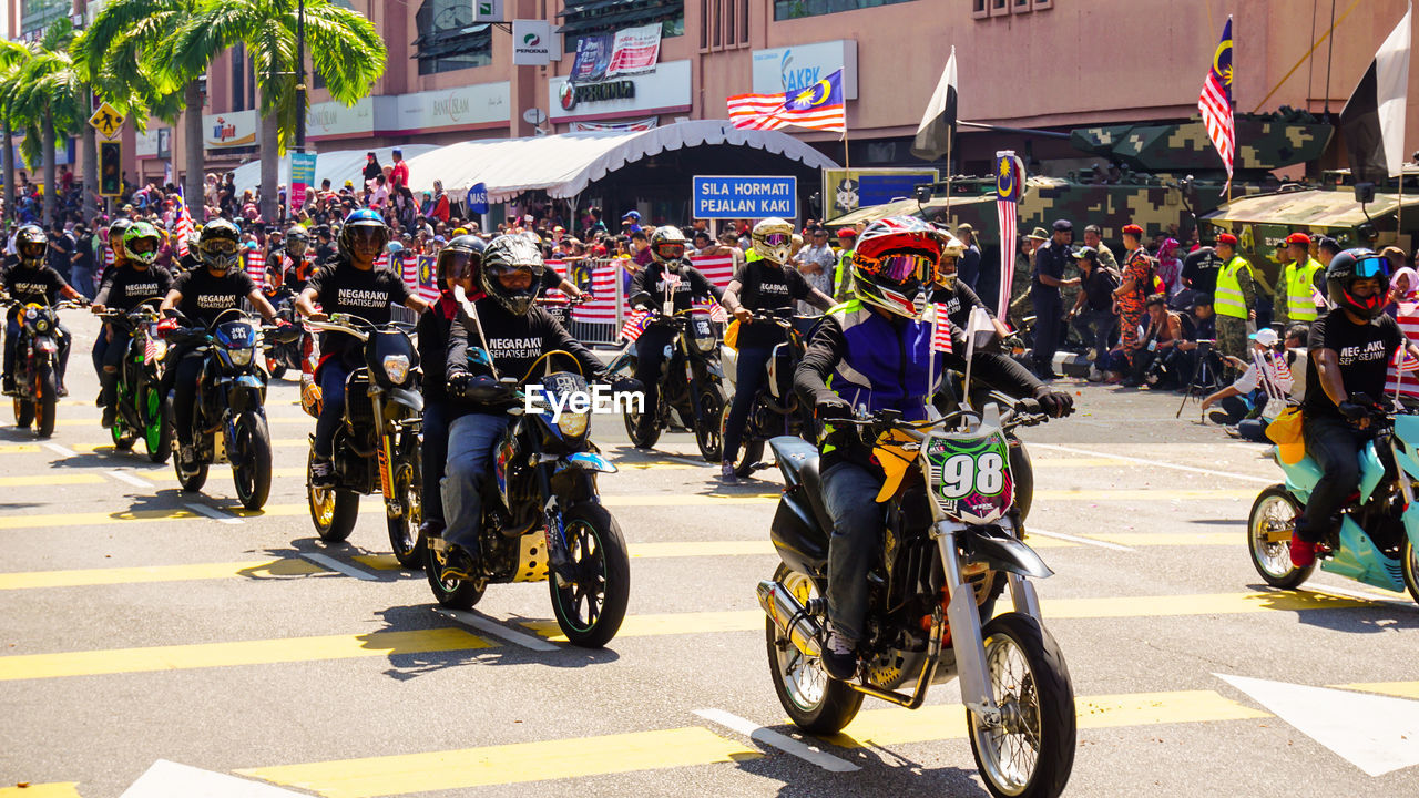 PEOPLE RIDING BICYCLE ON ROAD