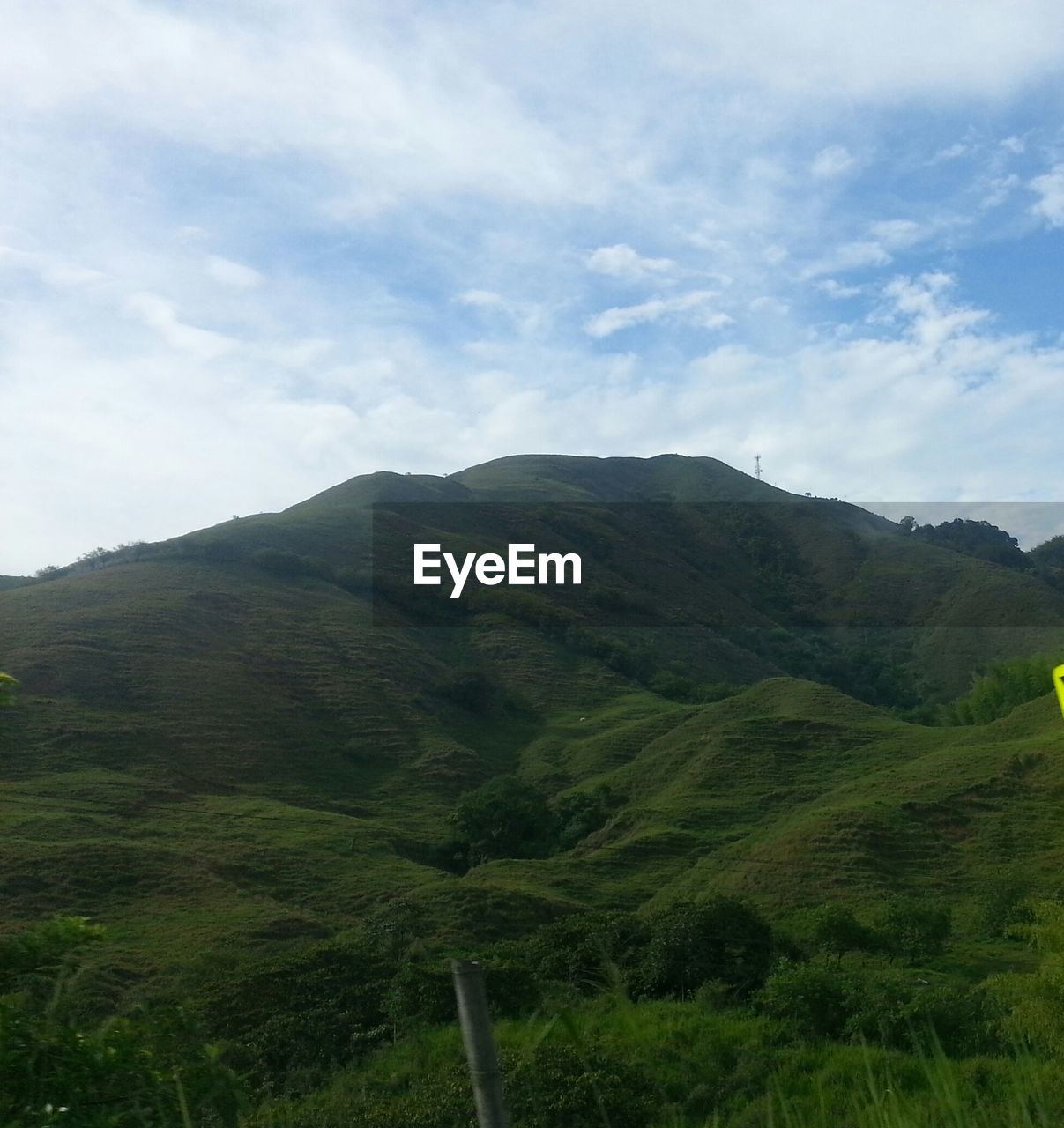 SCENIC VIEW OF MOUNTAINS AGAINST CLOUDY SKY