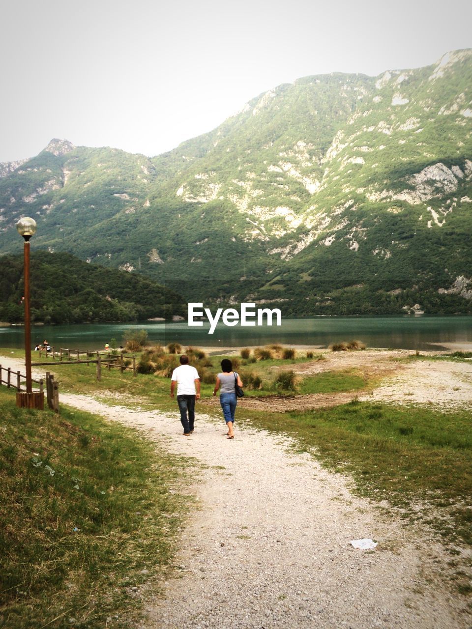 Couple walking by lake in mountains