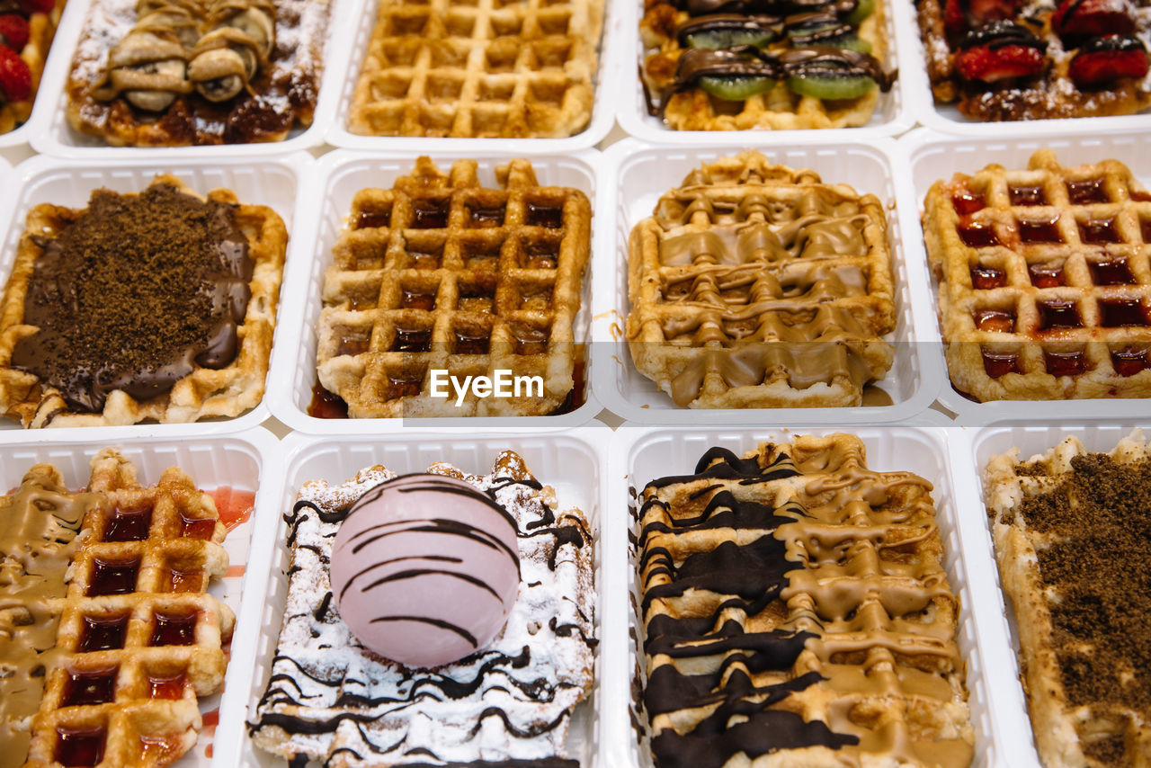 Full frame shot of ice cream over waffles in container for sale at parlor
