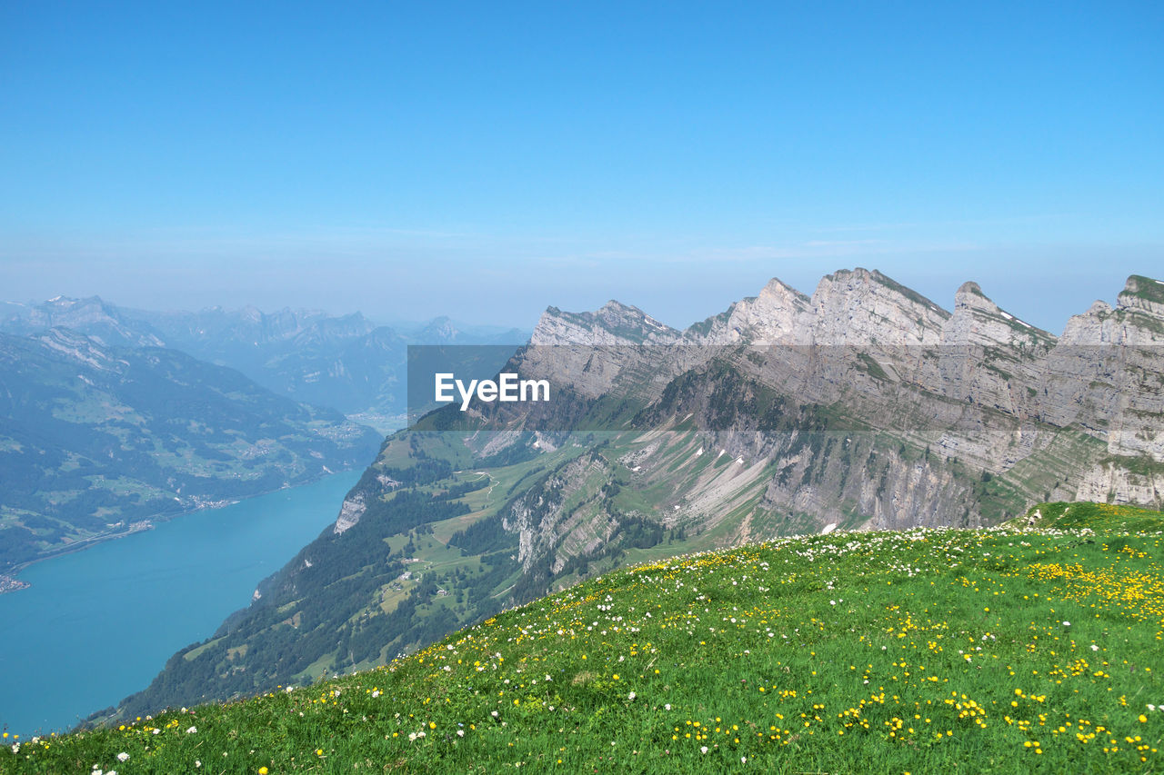 Scenic view of mountains against clear blue sky