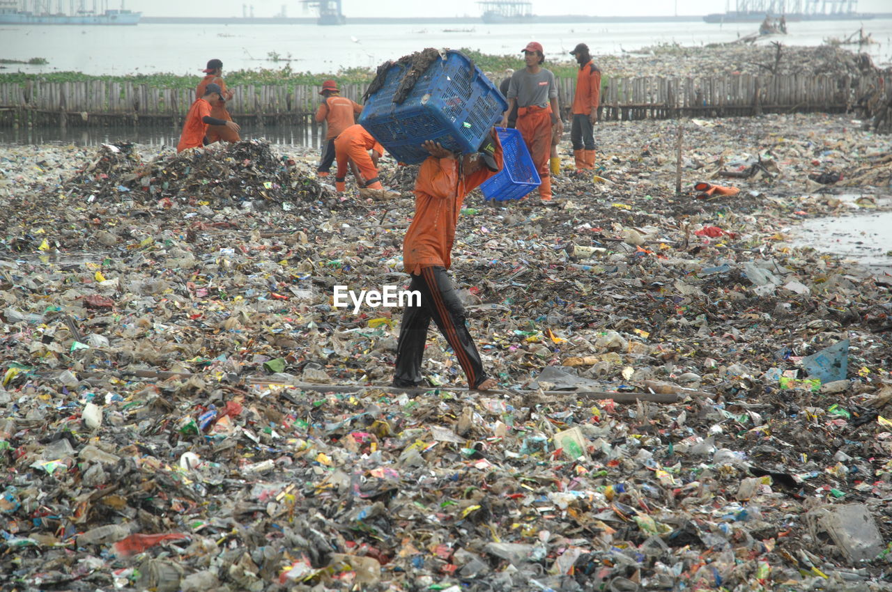 Sanitation workers cleaning garbage dump