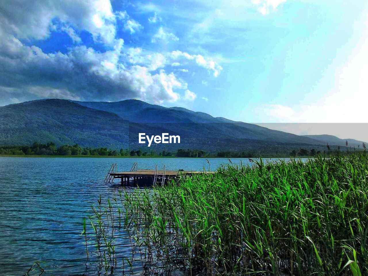 Calm lake with mountains in background