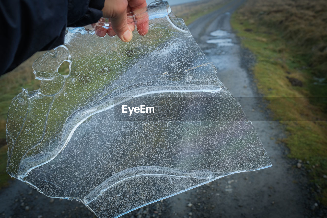 Cropped hand of man holding ice