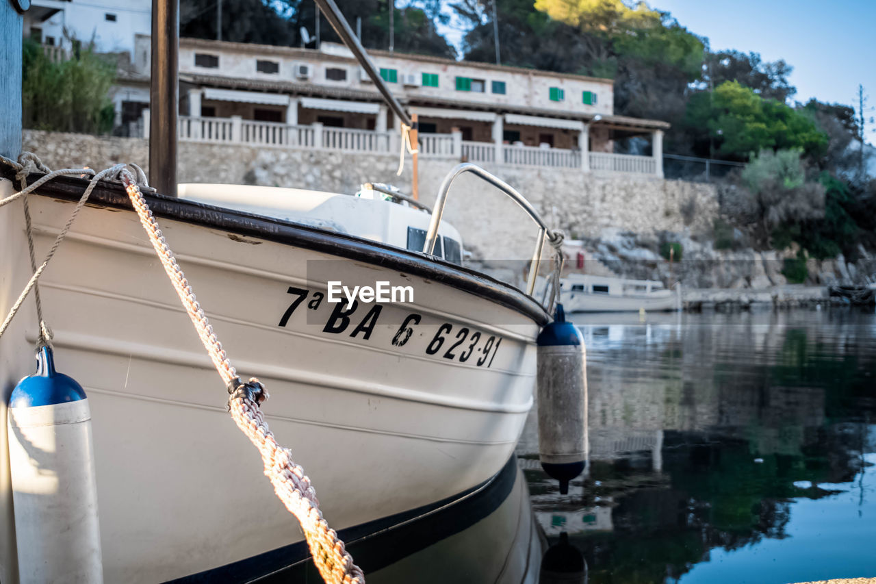 BOAT MOORED AT HARBOR