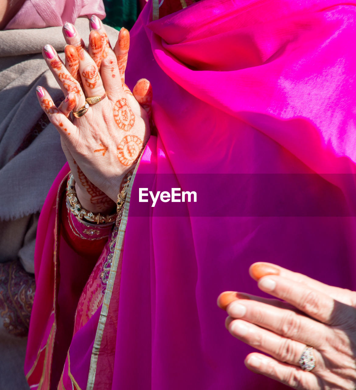 Close-up midsection of woman with hands clasped praying