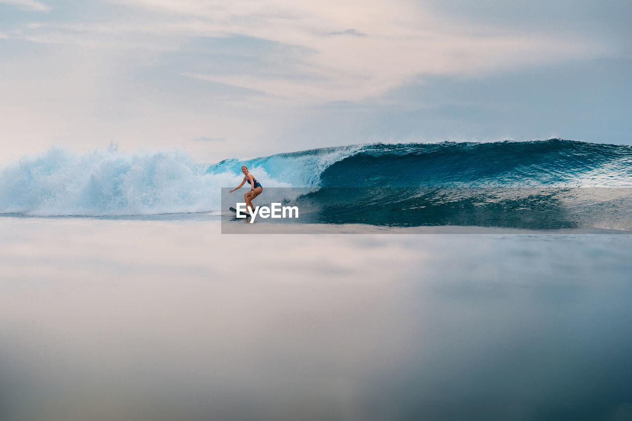 man skiing on sea against sky