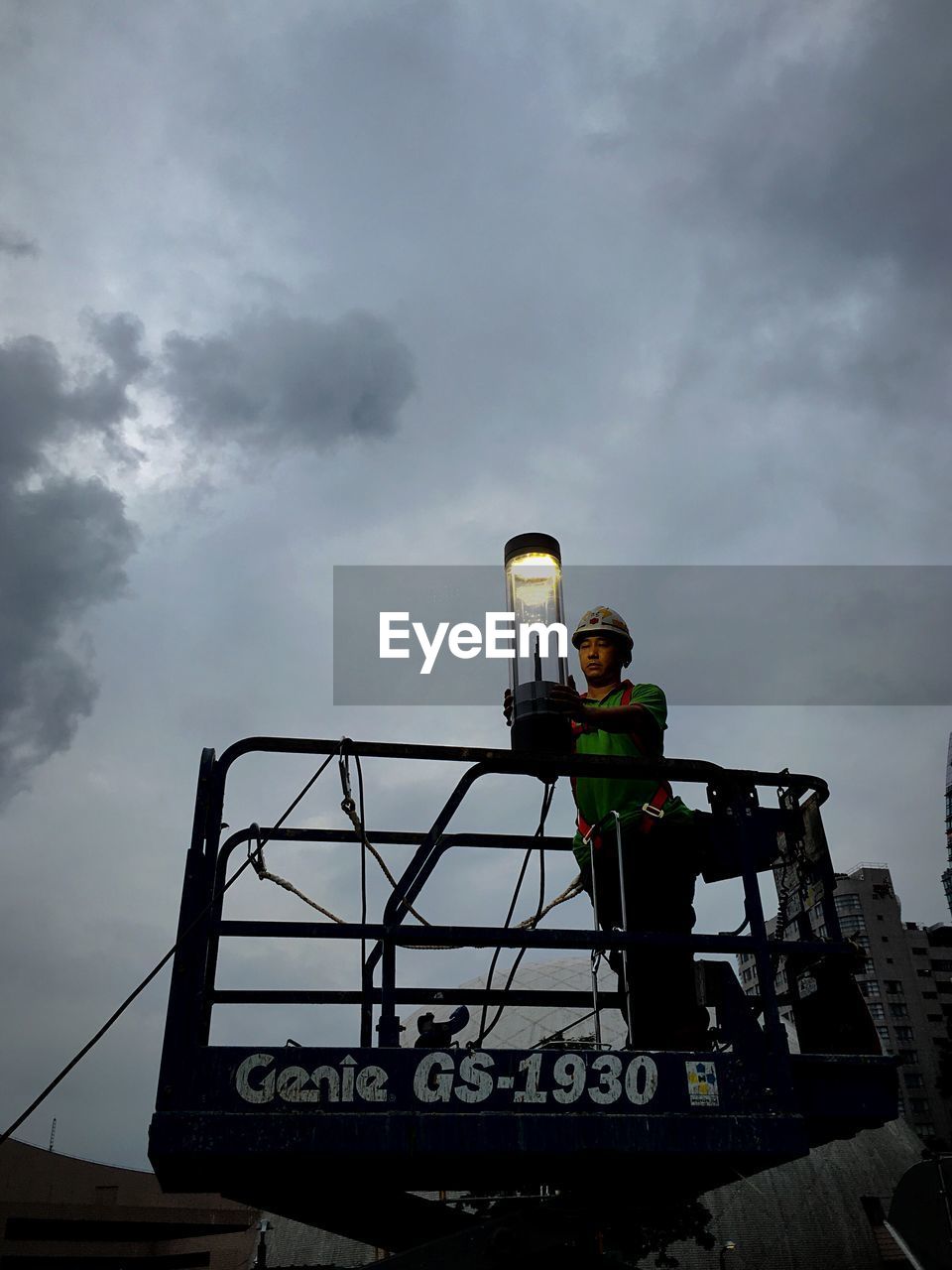 LOW ANGLE VIEW OF PEOPLE AGAINST CLOUDY SKY