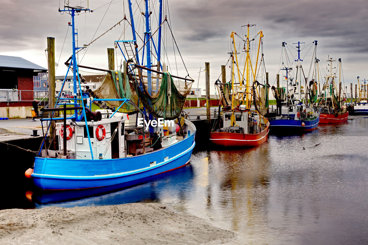 Fishtrawlers in a fish port at low tide