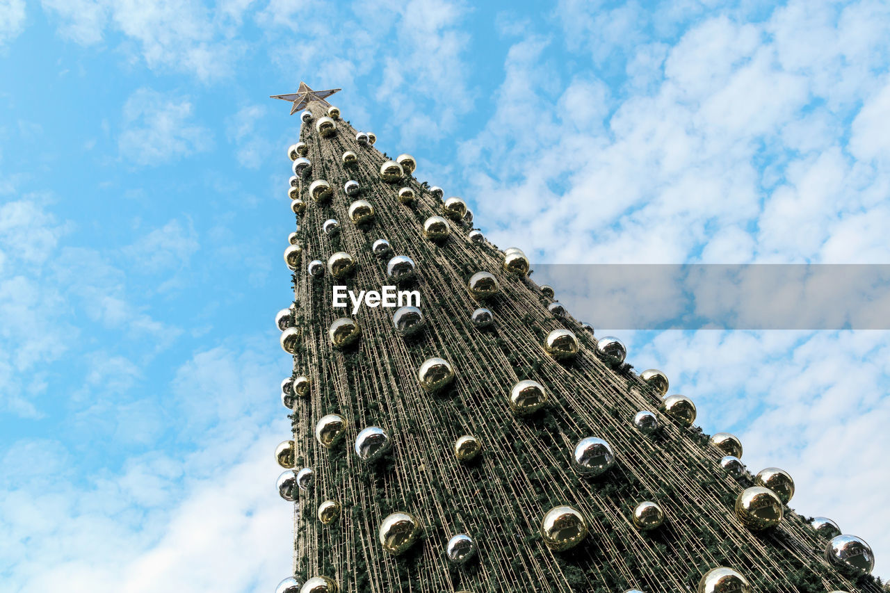 Outdoor christmas tree at daytime with beautiful blue sky