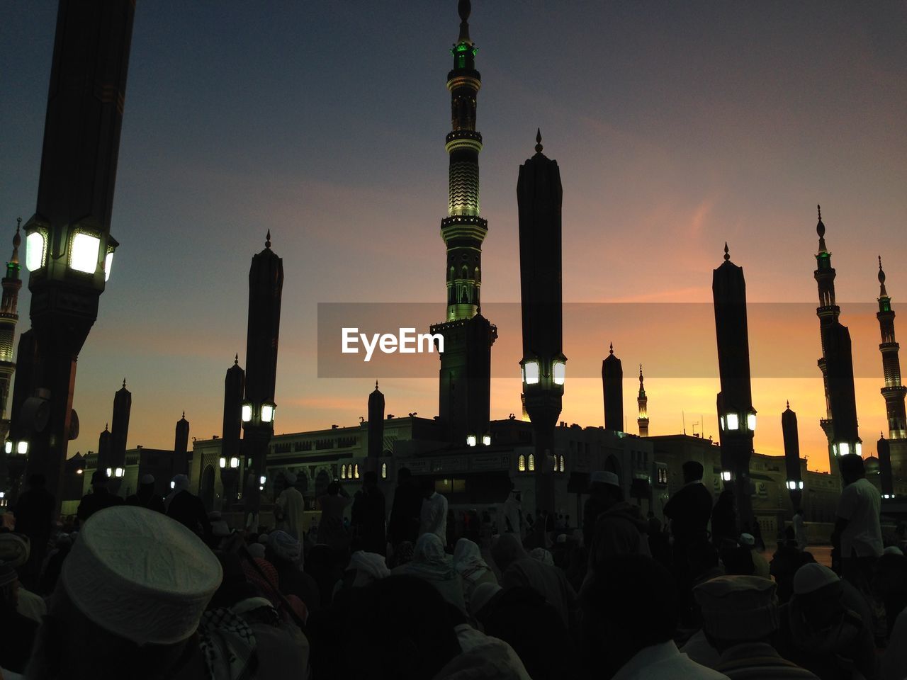 People in front of mosque during sunset