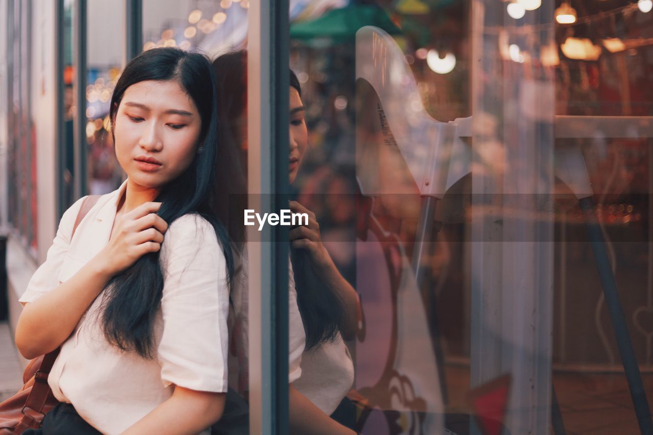 Woman against window