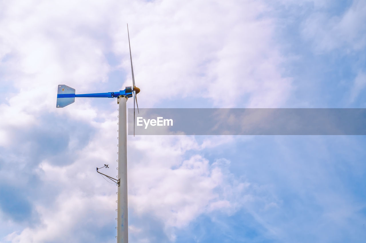 Low angle view of windmill against sky