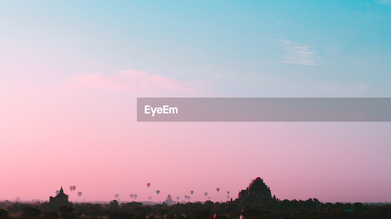 Silhouette trees against sky during sunset