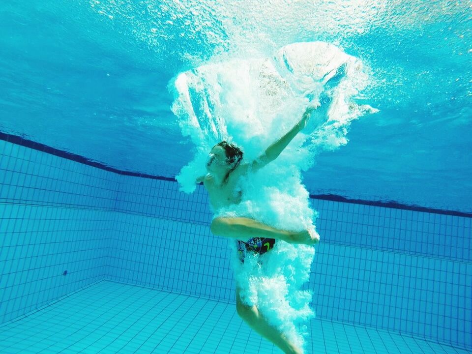 Swimmer jumping into swimming pool