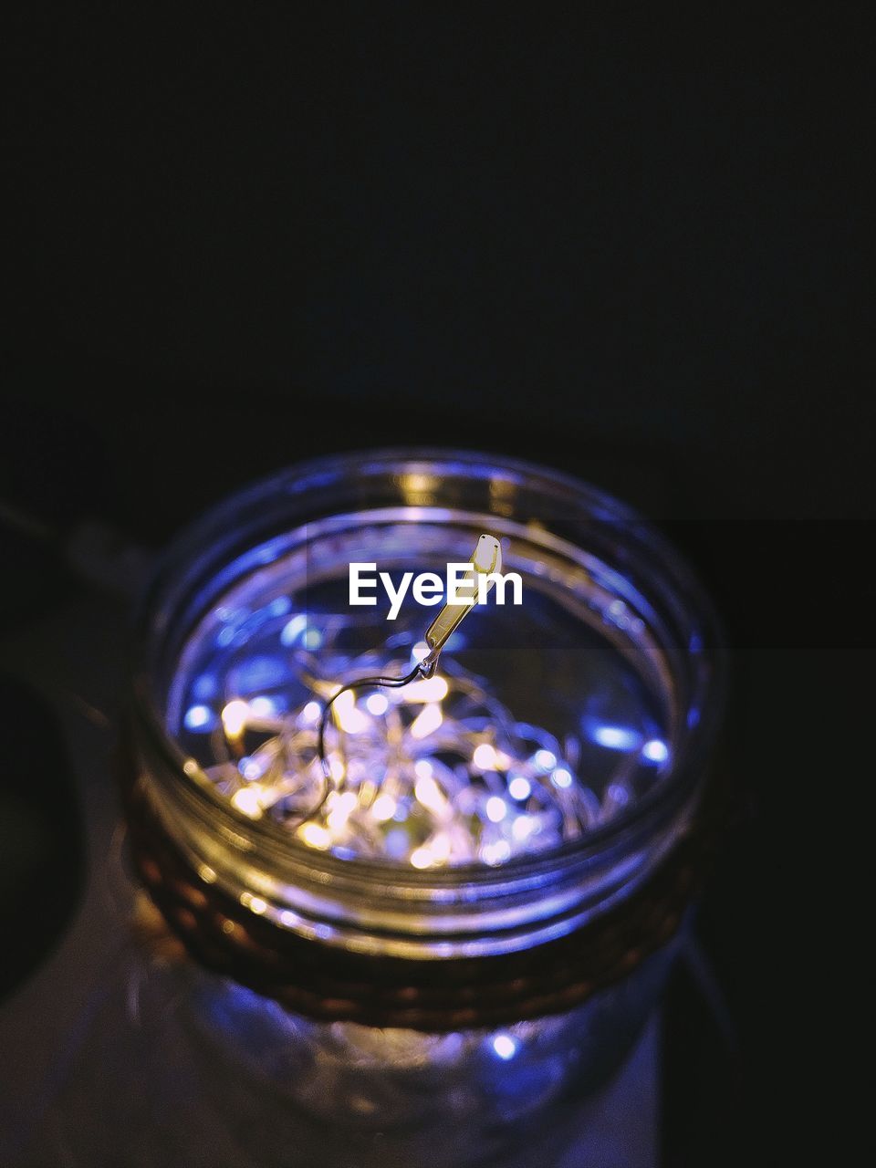 Close-up of illuminated lighting equipment in jar