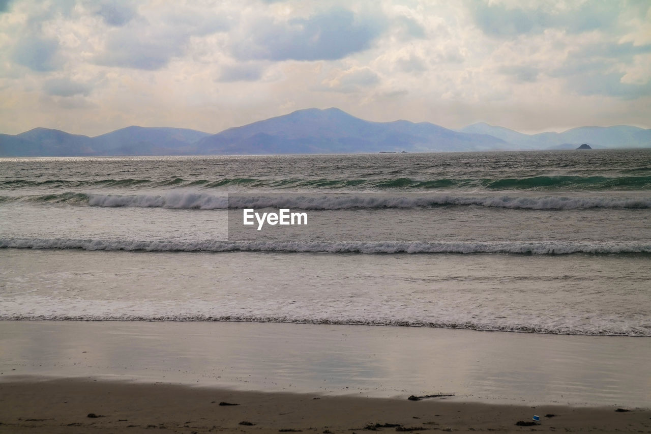 Scenic view of sea against cloudy sky