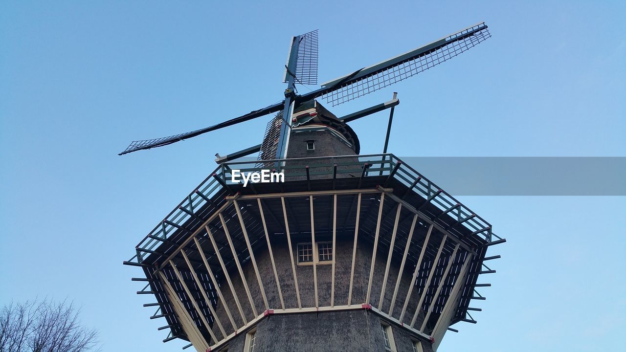 LOW ANGLE VIEW OF TRADITIONAL WINDMILL AGAINST CLEAR SKY