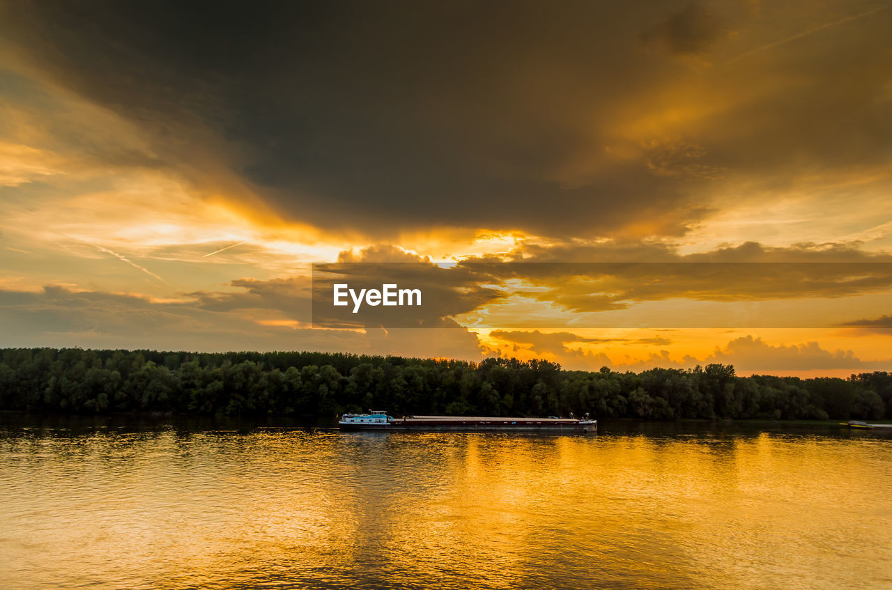 Scenic view of lake against sky during sunset