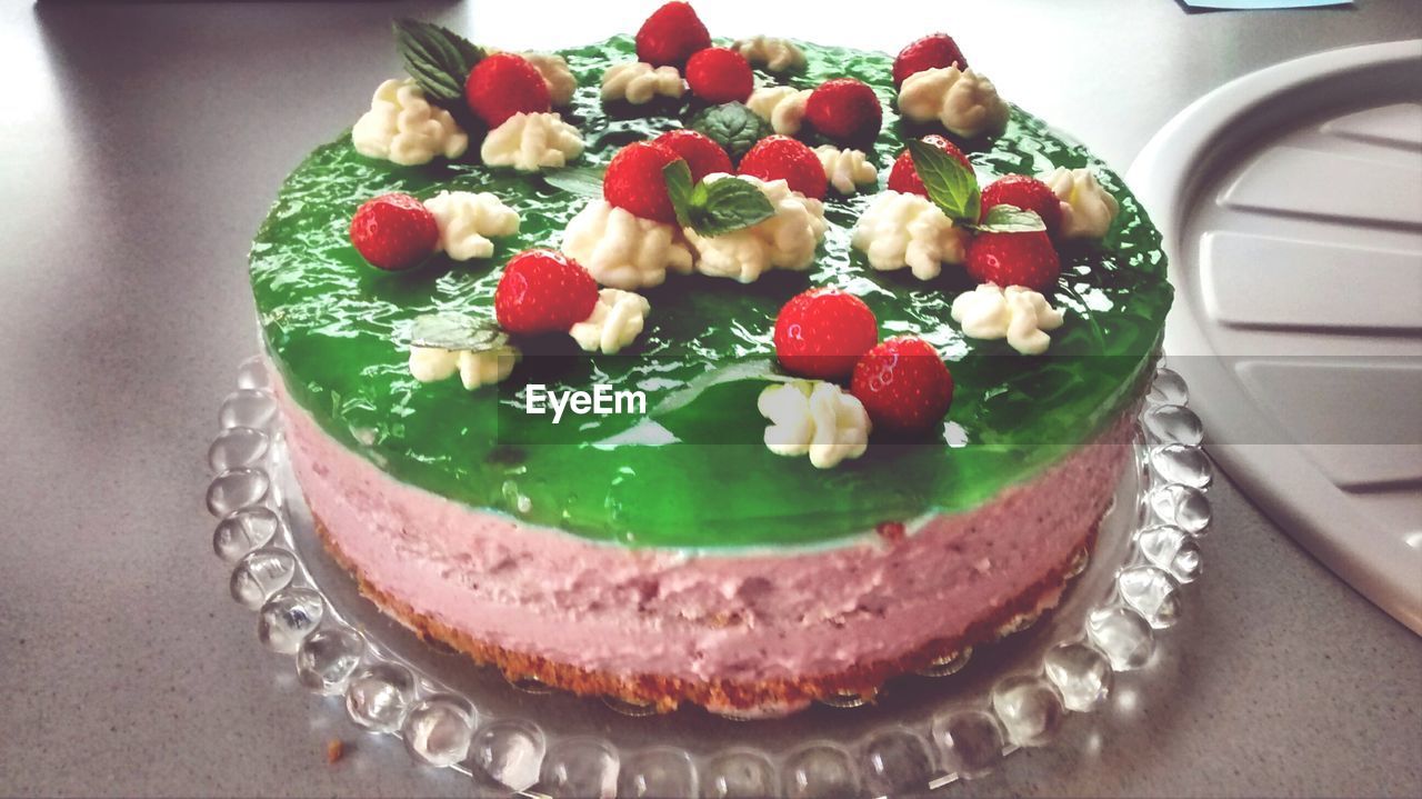 Delicious cake with strawberries on top