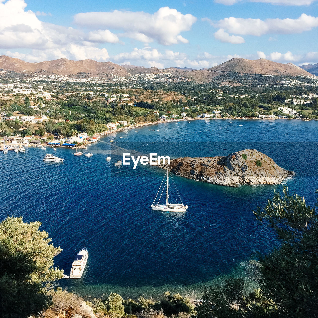 High angle view of boat moving on sea against mountain