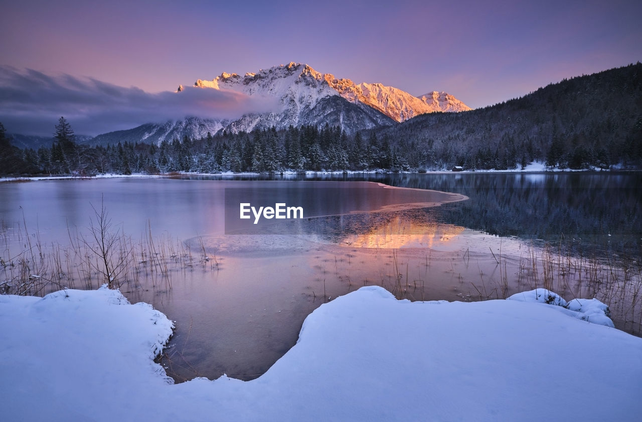 Scenic view of lautersee lake with karwendel mountain during sunset