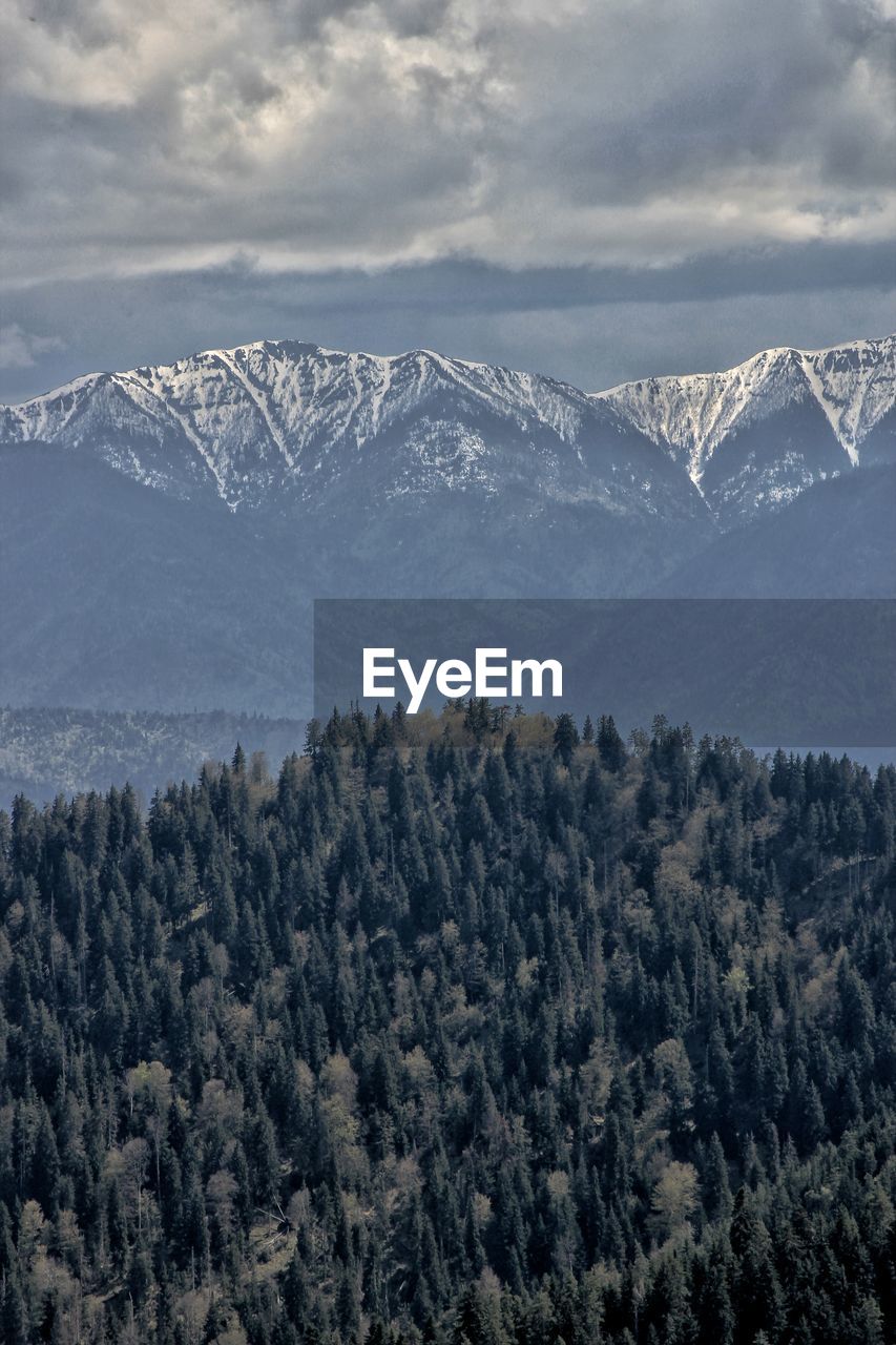 Scenic view of snow covered mountains against sky