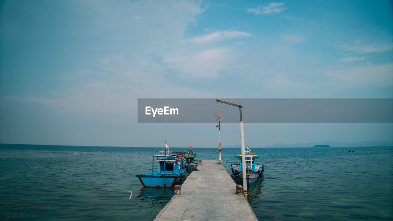 Pier over sea against sky in pahawang island