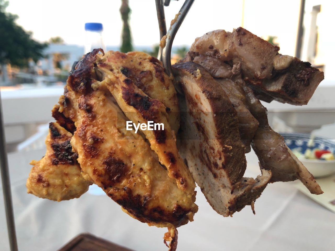 CLOSE-UP OF MEAT ON BARBECUE