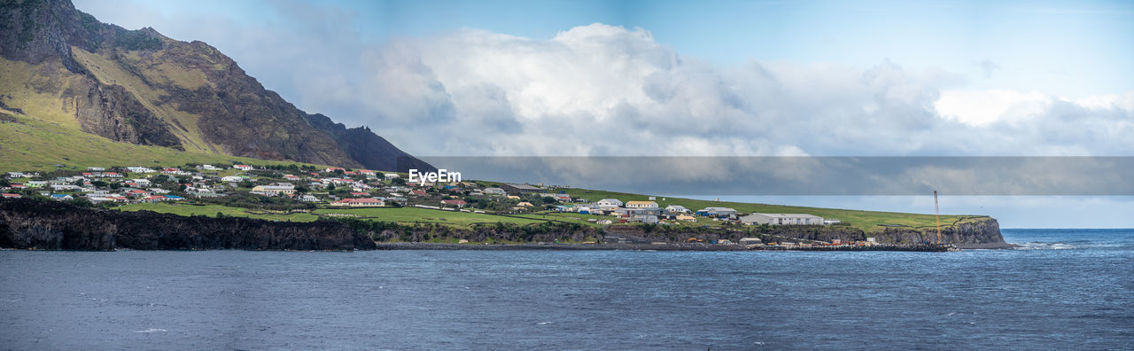 BUILDINGS BY SEA AGAINST SKY
