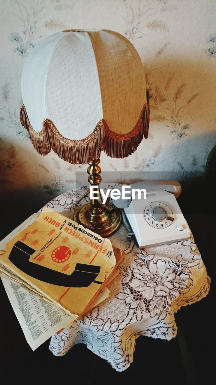 Lamp and telephone and books on table